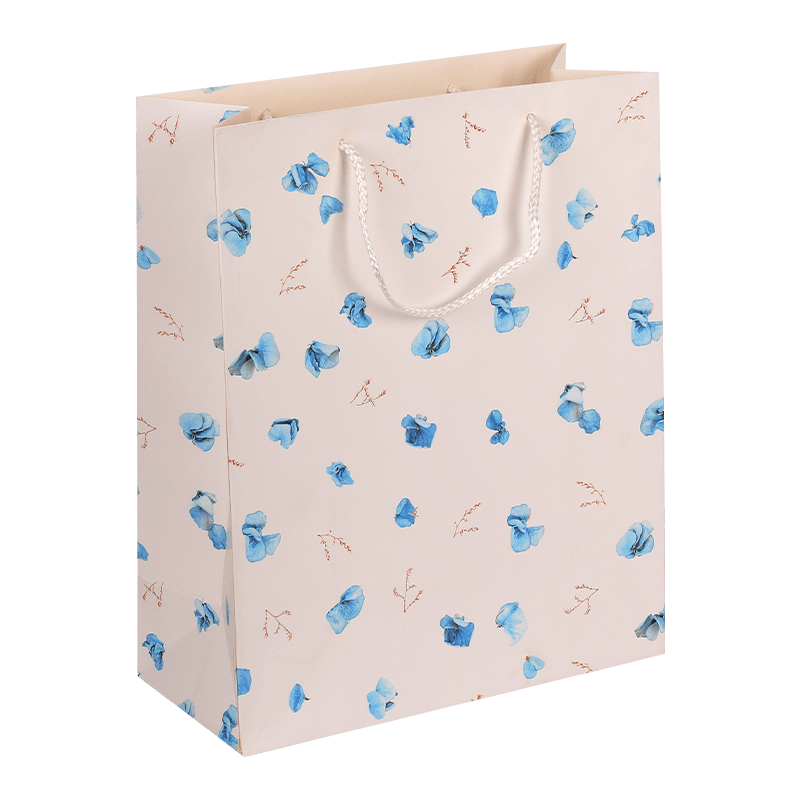 Geschenktüte aus Papier mit Blumenmuster und Griff